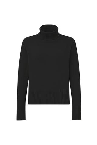 The Gia Turtleneck Sweater - Black is a stylish turtleneck featuring long sleeves, ribbed cuffs, and hem, designed with an oversized fit. Set against a white background, this sweater seamlessly combines comfort with fashion.