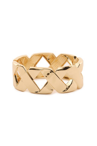 A gold ring featuring a crisscross lattice design, complemented by a polished and shiny finish, is presented against a plain white background. This piece exudes a modern sculptural touch, similar to the bold statement of the Gold Frankie Wrap Bangle.