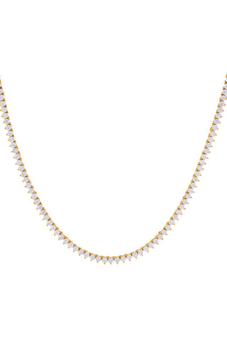 The Three Prong Tennis Necklace by Adina Eden is a delicate gold-plated piece adorned with numerous small, closely set white gemstones, creating a shimmering and intricate design that evenly encircles the neck. This CZ tennis necklace exhibits both elegance and fine craftsmanship.