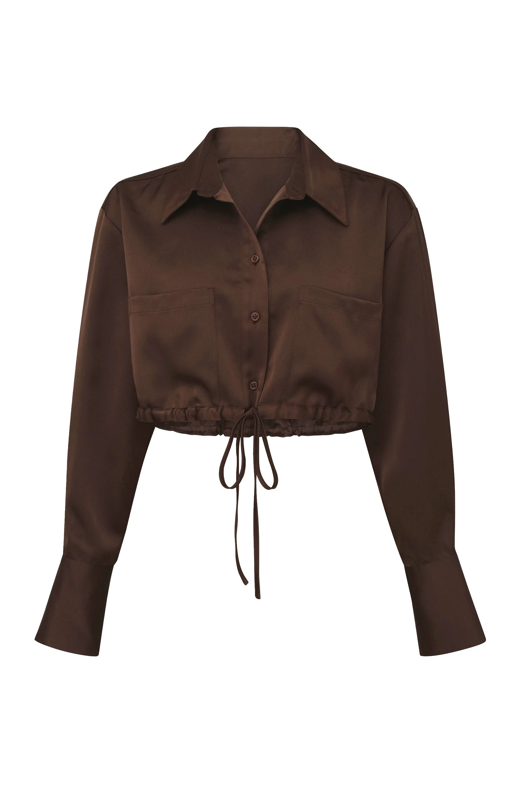 The Milan Satin Button Up - Espresso is a dark brown crop top with a collared neckline and button-down front. This shirt features two cargo-style pockets on the front, a tie-waist that creates gathered detailing, and slightly flared cuffs for a unique touch to the classic design.