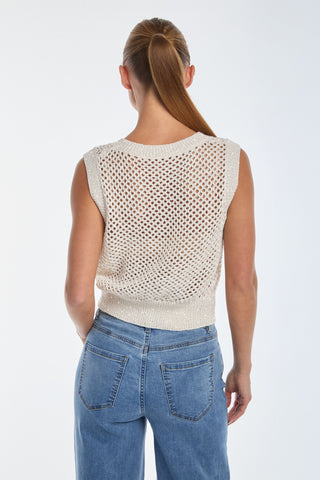 A person with a ponytail is seen from the back wearing an Addison Sequin Crochet Top in Pearl, a sleeveless piece with a knit mesh pattern, paired with blue jeans against a plain light background.