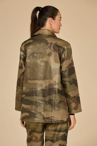 A person with long dark hair styled in a ponytail is seen from behind, wearing the Milan Gold Dusted Cargo Jacket in camo, along with matching utility pocket pants, set against a solid beige background.