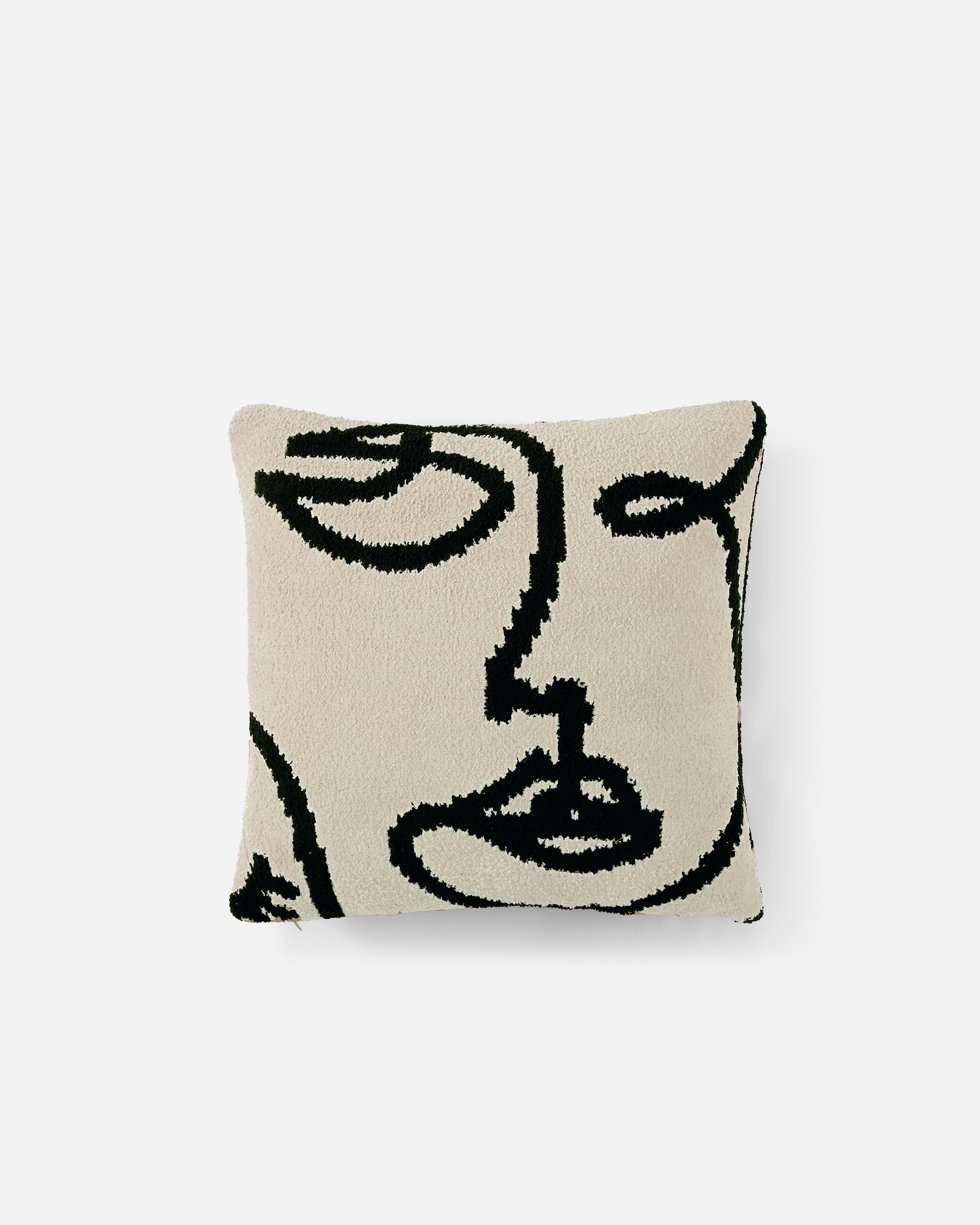 The Faces Throw Pillow by Sunday Citizen is a square cushion with a beige background that features an abstract black line drawing of a face. This memory foam design embodies a modern and minimalist aesthetic, with elements of the face, including the eyes, nose, and lips, depicted in a continuous, flowing style. Additionally, it is conveniently machine washable.