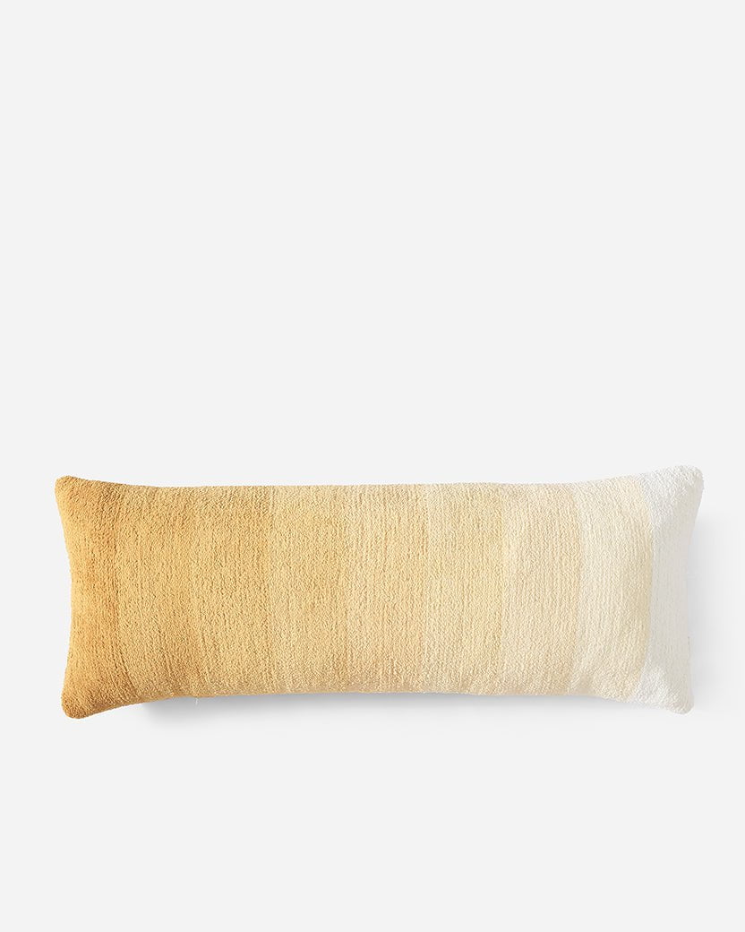 A rectangular throw pillow with a gradient color scheme, transitioning from dark mustard yellow on the left to light beige in the center, and finally to off-white on the right. The Ombre Lumbar Pillow by Sunday Citizen has a textured surface and is set against a white background.