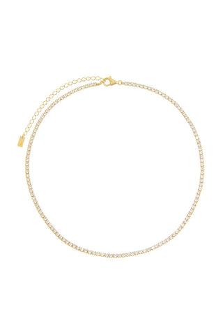 The Thin Tennis Choker by By Adina Eden is a dazzling piece adorned with small, clear gemstones set on gold-plated sterling silver. It features a lobster clasp and an attached chain for size adjustment.