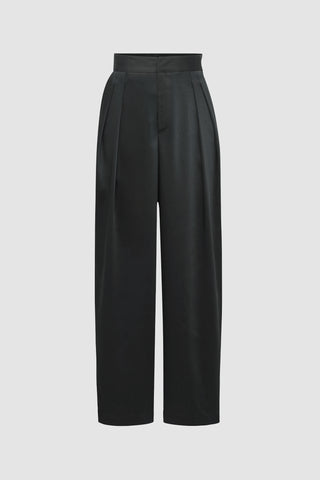 Introducing the Valentina Satin Pant - Black: high-waisted, wide-leg trousers with front pleats and a tailored look. These pants feature a subtle sheen, beautifully offset against a neutral backdrop.